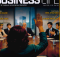 Back of a woman raising her hand in a boardroom during a meeting; magazine cover 'Business Life' with executives around a conference table in the background, and bold Turkish text about women in leadership.